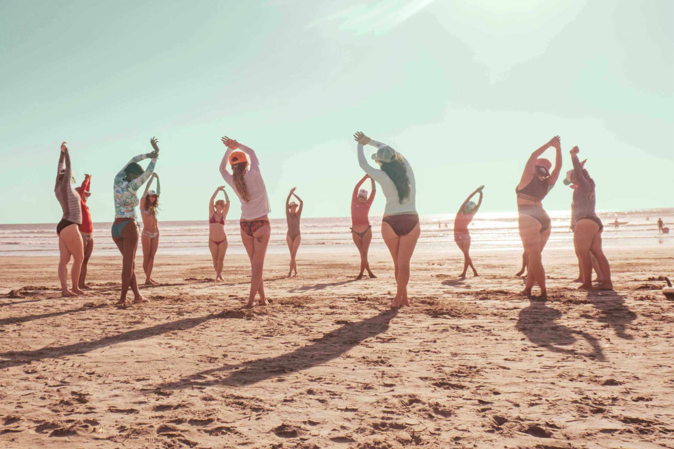 women stretching on the beach